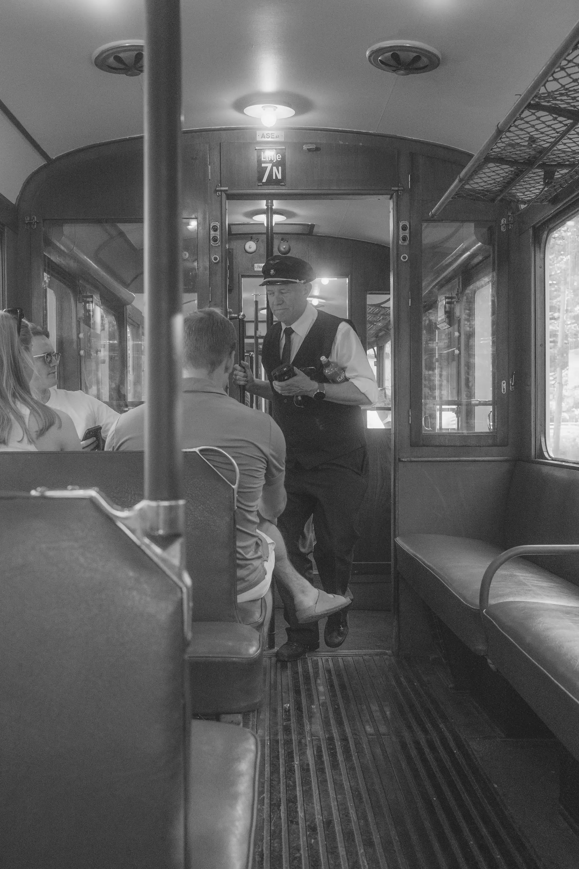 A ticket inspector in an old tram.