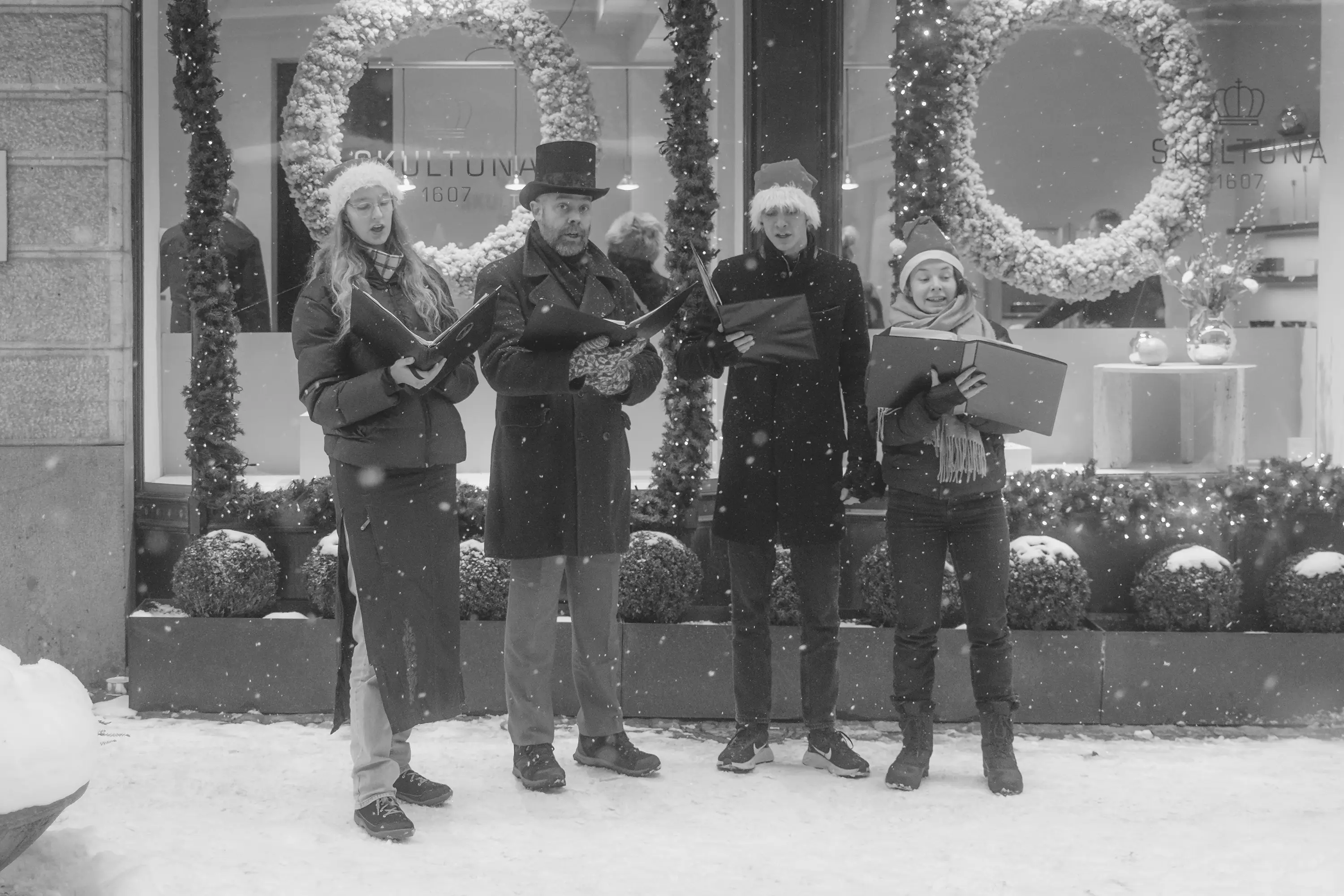 A group of people singing christmas carols