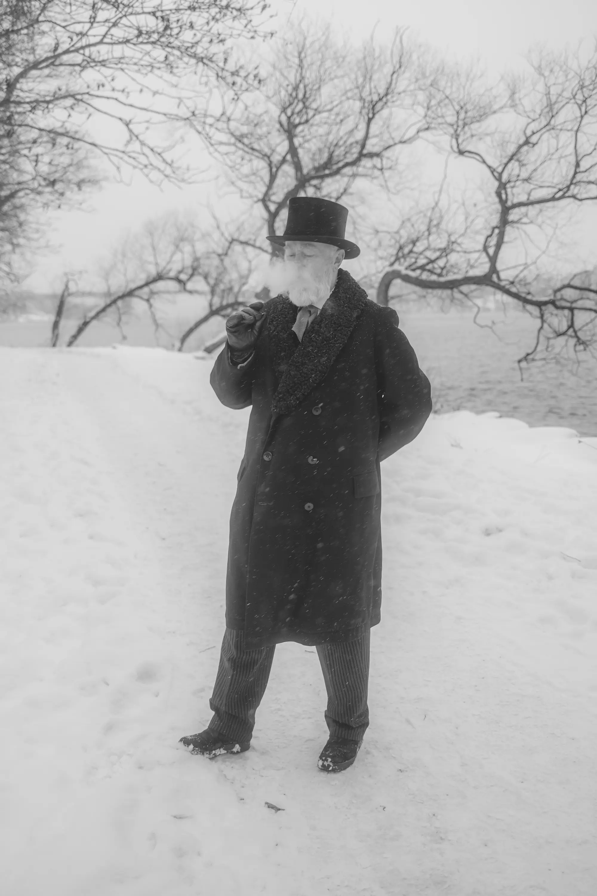 A gentleman with a cigar blowing smoke