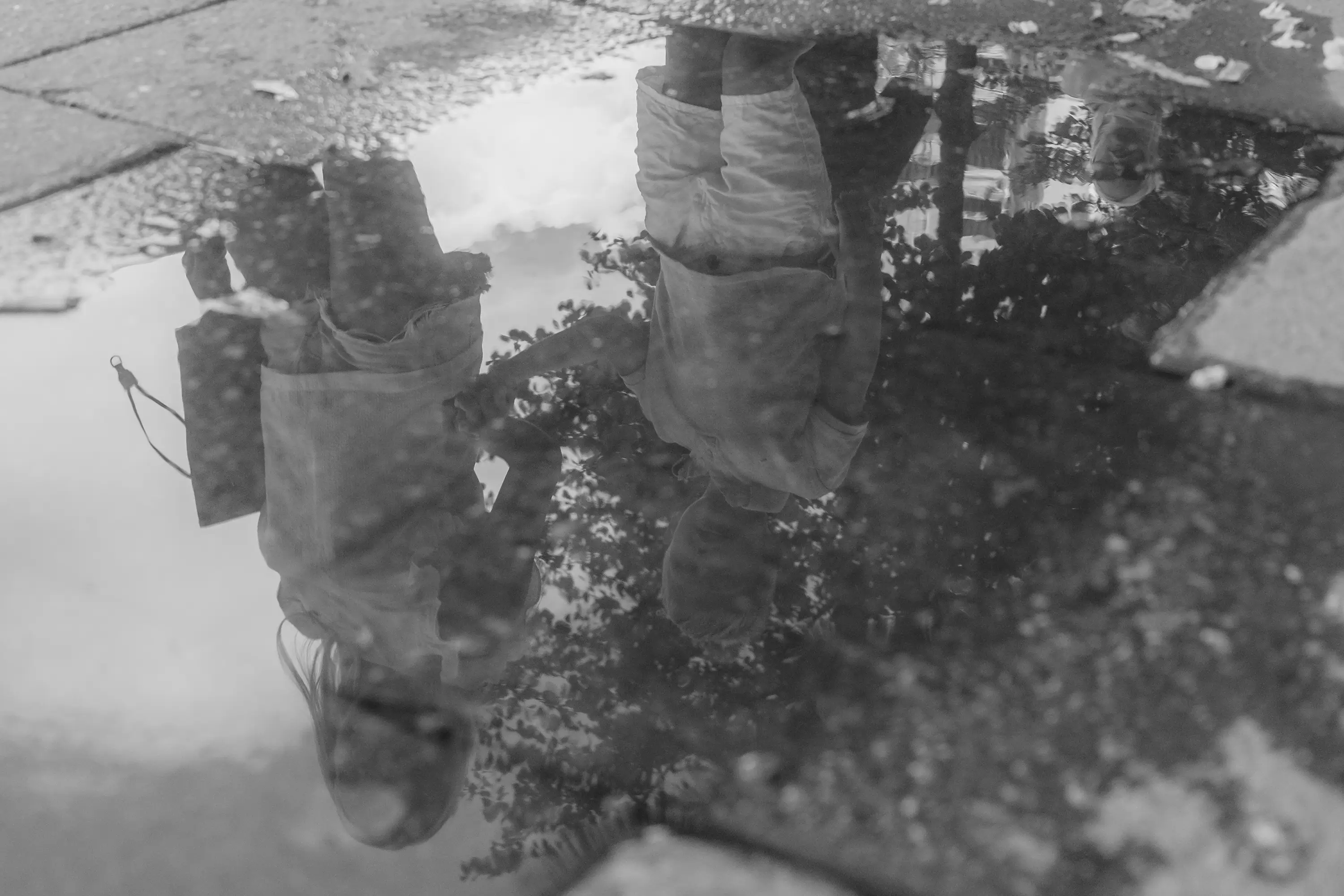 Mother and son reflected on a puddle